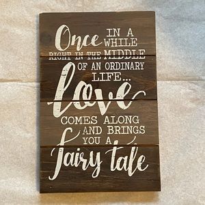 LOVE FAIRYTALE wood decor sign. Brown stained wood base with white text.